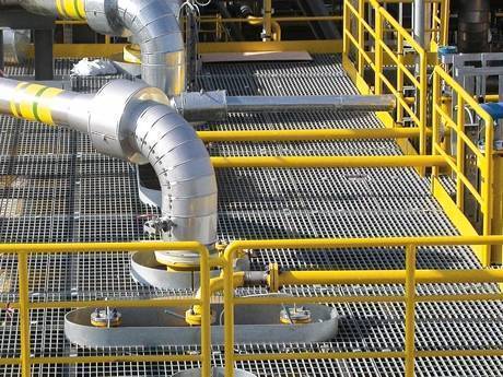 Steel grating platform at high level and metal pipes through platform directly.